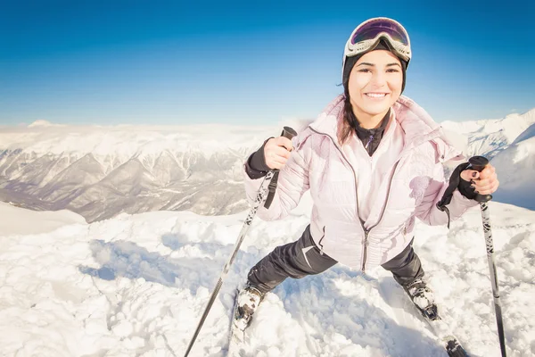 Ski. Happy sport woman in snowy mountains