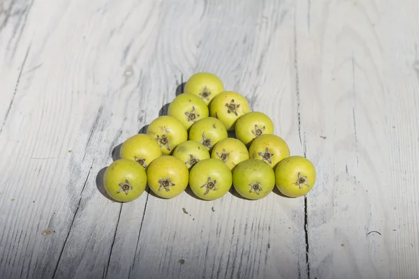 Green fruits on wooden background