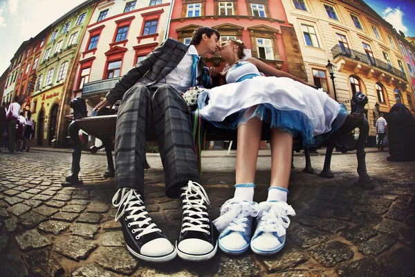 Happy creative wedding couple, with converse sneakers old city b