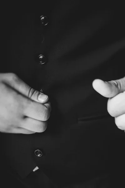Man's hand corrected black jacket