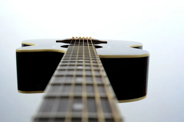 Acoustic guitar string close up. White background .