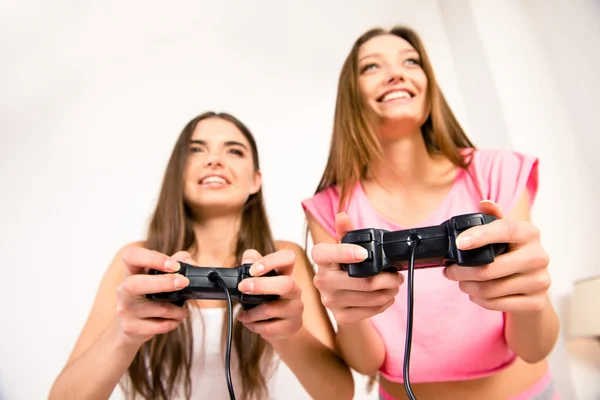 Close up photo of smiling cute friends playing video games