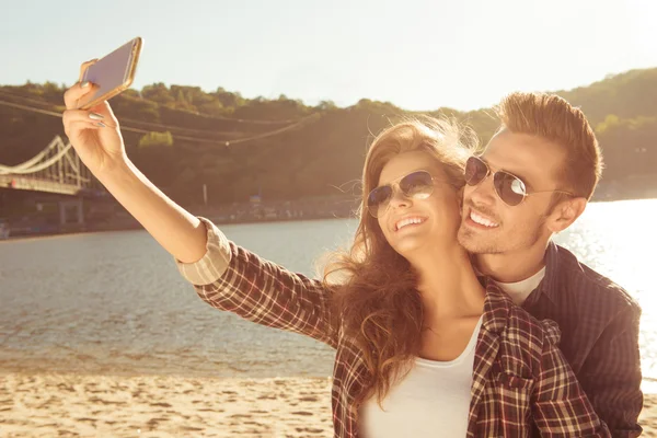 Couple in love making selfie photo on the beach