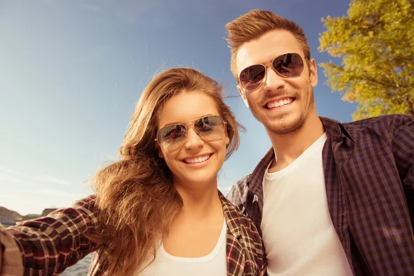 Happy couple in love in glasses making selfie