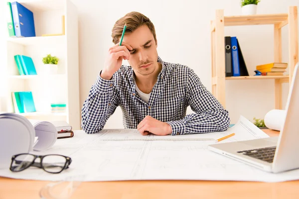 Ponder tired architect thinking about way to draw scheme