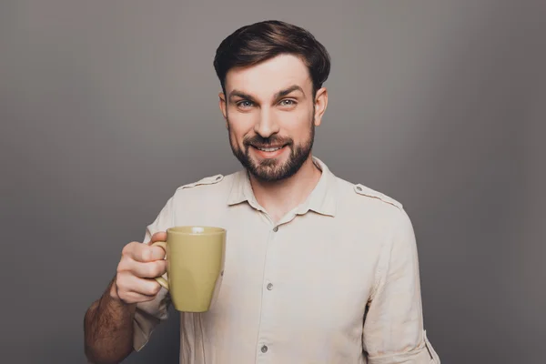 Happy smiling man having break and drinking coffee