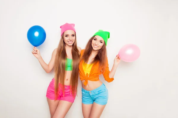 Happy pretty women holding balloons for birthday party