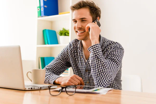 Happy young man having talk with his clients