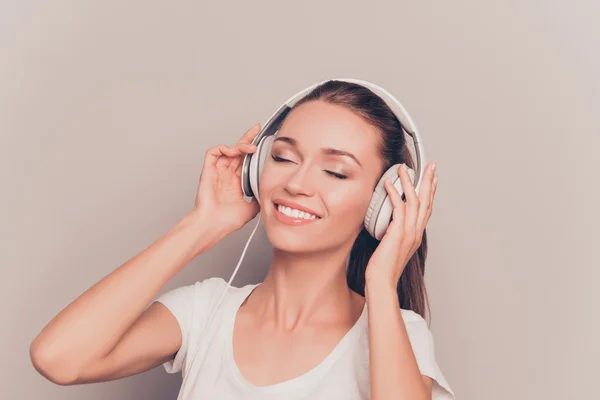 Cheerful relaxed music lover listening music in headphones