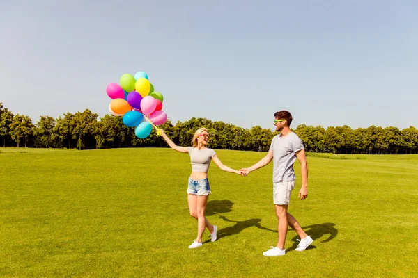 Young happy family having romantic walk with balloons