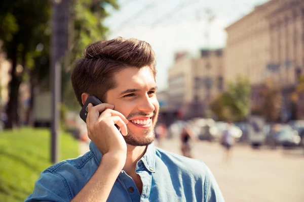 Close up portrait of a handsome man talk on phone and walk stree