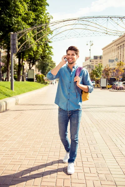 Handsome happy man talk on phone and walk  street