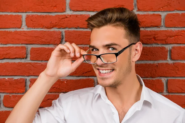 Subtle handsome man holding his glasses