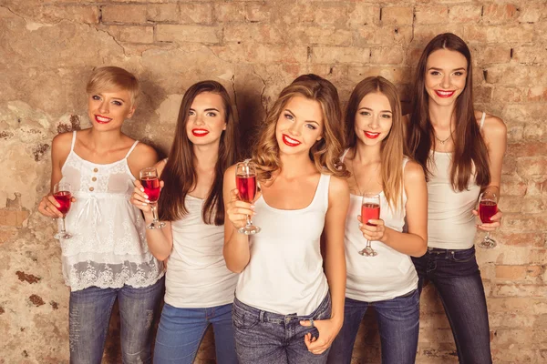 Beautiful young women wearing dress code celebrating with red ch