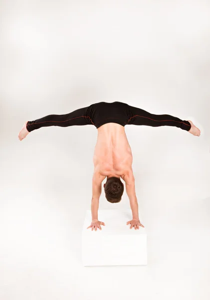 Man stretch gymnastic balance posture isolated studio on white b