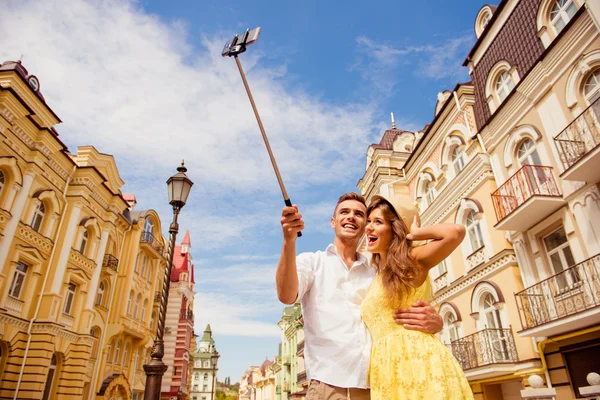 Couple in love making selfie photo on self stick