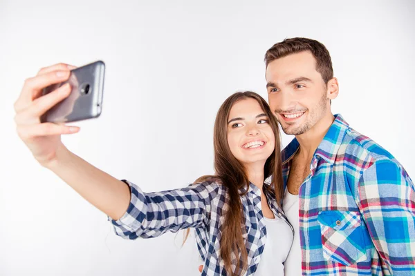 Cheerful pretty couple in love making selfie