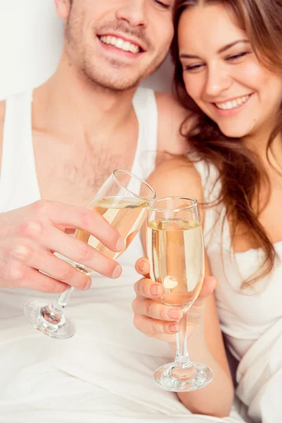 Cheers! Couple in love celebrate honeymoon with champagne on the