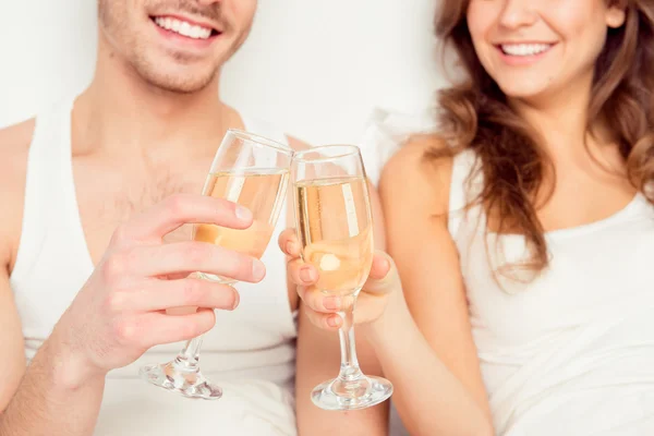 Close up photo of couple in love with glasses of champagne