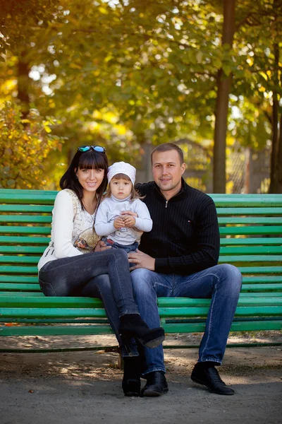 Happy mother, father and daughter in the park