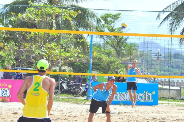 Nha Trang, Vietnam - July 12, 2015: Players are playing in a match in a beach volleyball tournament in Nha Trang city
