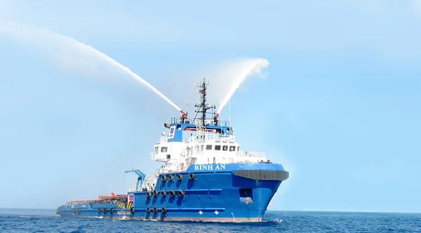 Vung Tau, Vietnam - May 29, 2016: An oil transportation ship  is blowing water in the sea