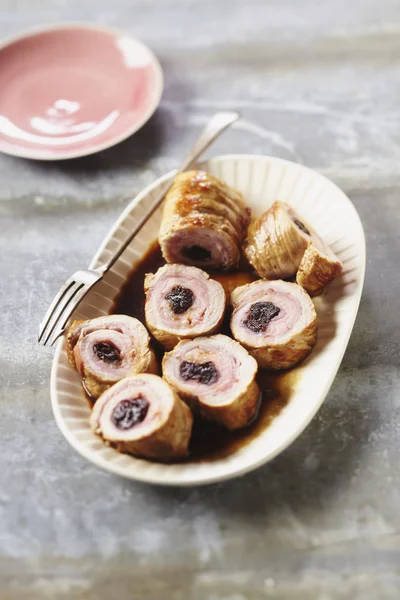 Veal rolled with bacon and prunes in plate in restaurant