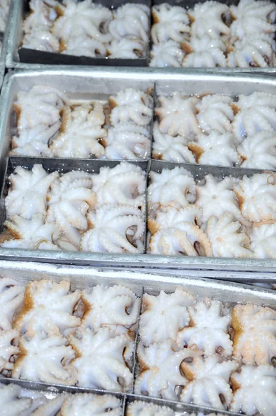 Octopus raw material is ready to be frozen in tray in a seafood factory in Vietnam