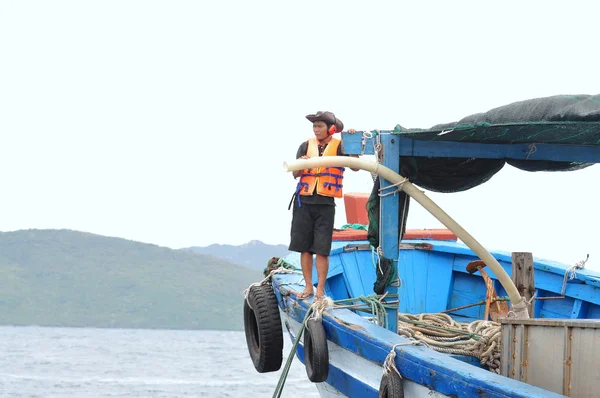 Nha Trang, Vietnam - June 23, 2013: Feeding barramundi fish by machine in cage culture in the Van Phong bay in Vietnam