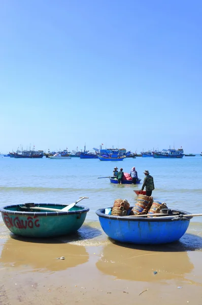 Lagi, Vietnam - February 26, 2012: Local fishermen are preparing their basket boat for a new working day in the Lagi beach