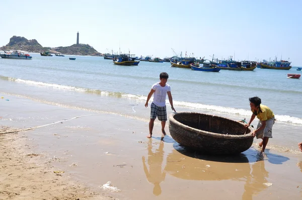 Lagi, Vietnam - February 26, 2012: Local fishermen are preparing their basket boat for a new working day in the Lagi beach