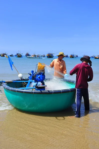 Lagi, Vietnam - February 26, 2012: Local fishermen are preparing their fishing nets for a new working day in the Lagi beach