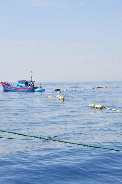 Nha Trang, Vietnam - May 4, 2012: Fishing boats are preparing to trawl in the sea of Nha Trang bay in Vietnam