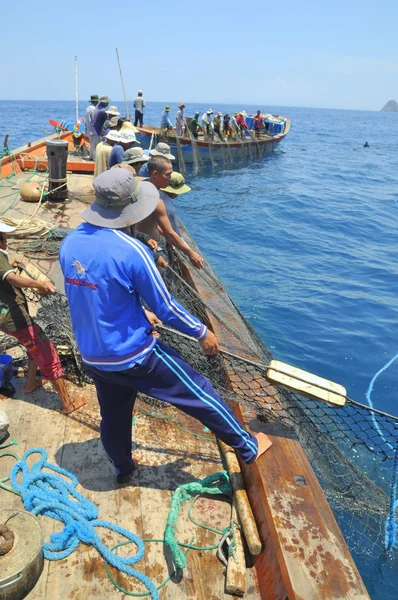 Nha Trang, Vietnam - May 5, 2012: Fishermen are trawling for tuna fish in the sea of Nha Trang bay in Vietnam