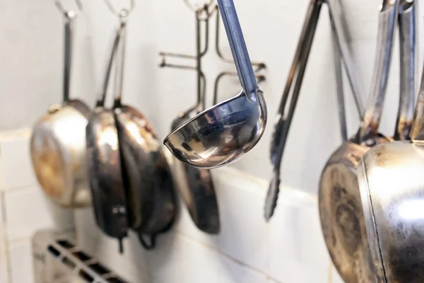 Kitchen utensils hanging from the wall