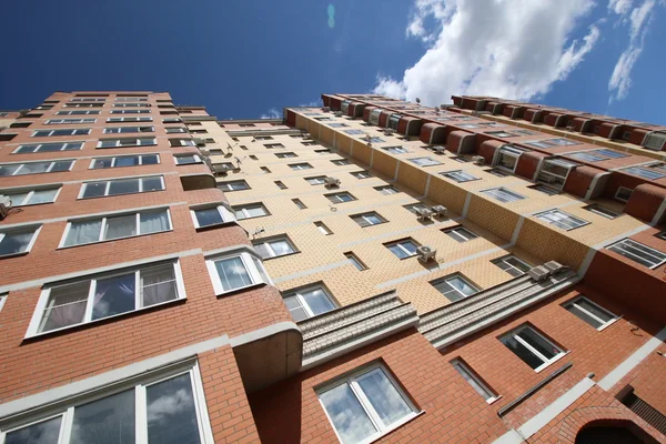 Modern high-rise apartment house on a background sky