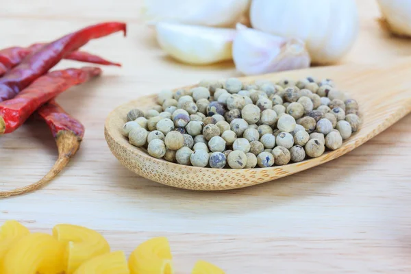 Close up white pepper in wooden spoon