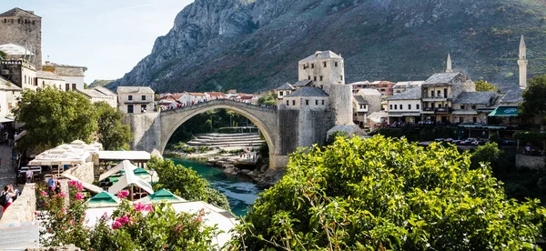 Mostar, Bosnia and Herzegovina - September 14, 2015: Tourist at the old bridge of Mostar which was destroyed in the war and rebuild in 2004. It is a tradition for men to dive off bridge.