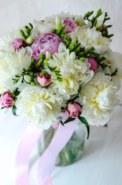 Bride bouquet of wedding flowers pink peony in vase on white background