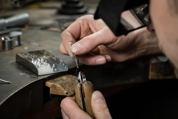 Man Putting diamond on ring