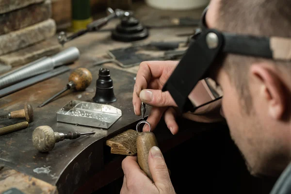 Man Putting diamond on ring