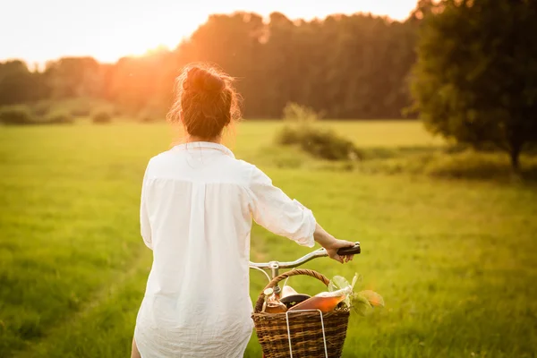 Woman riding bicycle with the basket