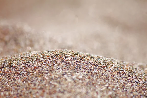 Sea run-multicolored sand on the beach close-up