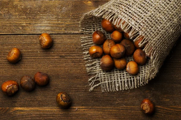 Pile of hazelnuts in shell on wooden table