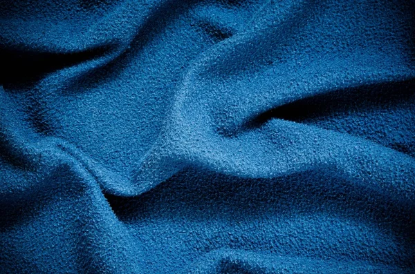 Blue wrinkled fabric texture.