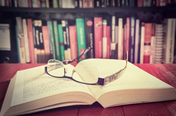 An open book and glasses.