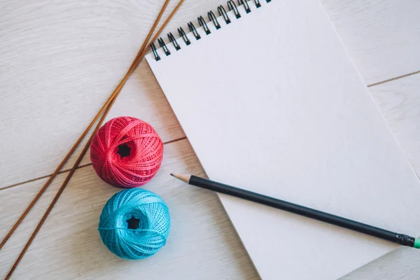 Notebook and cotton yarn balls