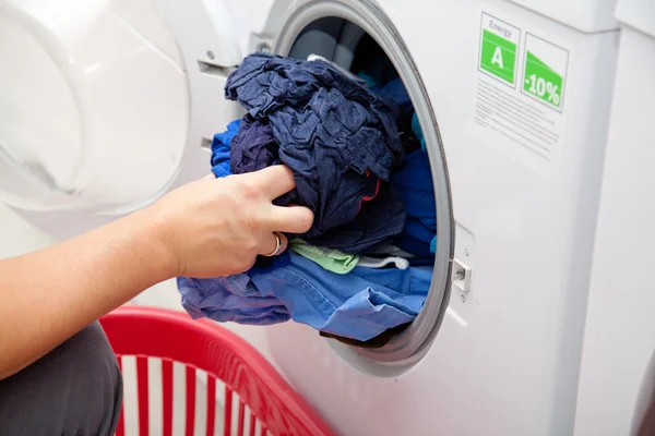 Woman taking laundry out of the washing machine
