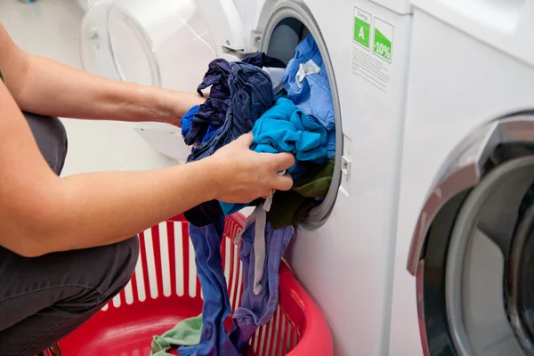 Woman taking laundry out of the washing machine