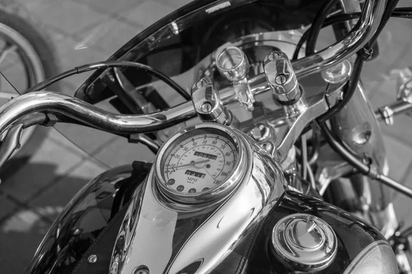 Chromed Motorcycle steering wheel. Instruments. Reservoir. Black and white photo.
